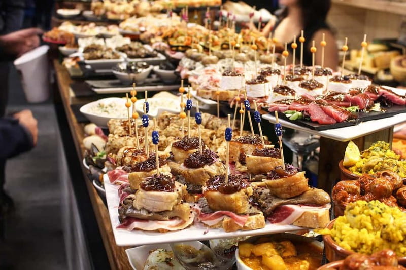 Barcelona: The Ultimate Local Tapas & Drinks Food Tour - Stop three: seafood, montaditos, and the pleasure of variety