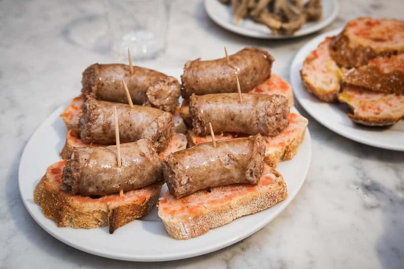 Barcelona: The Ultimate Local Tapas & Drinks Food Tour - Walking through the Gothic Quarter with a plate in hand