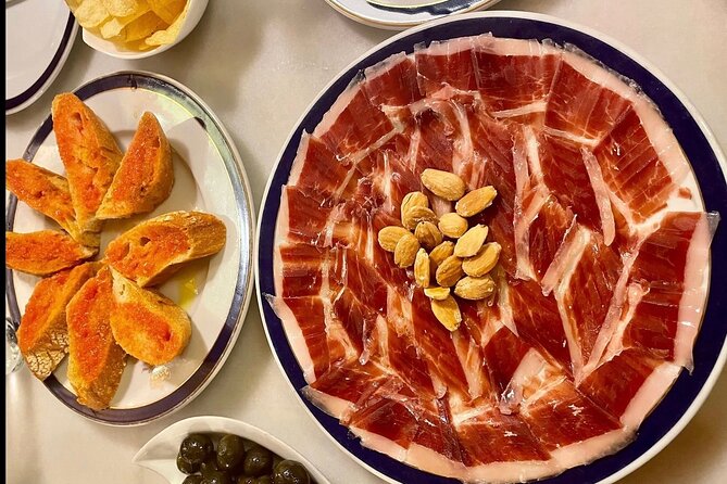 Half Day Private Madrid Tapas and History Walking Tour - Bar three: wine, tapas, and a shop setting