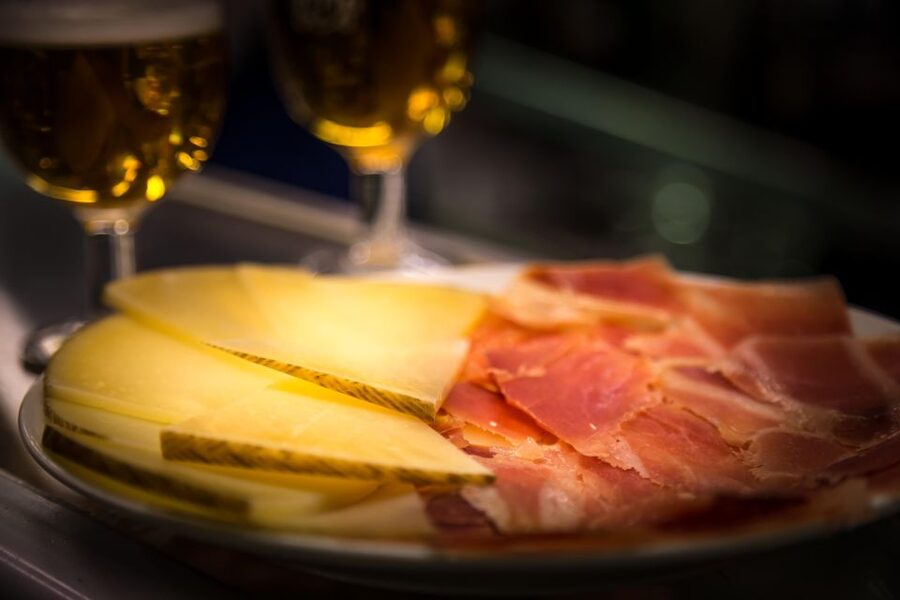 Madrid: Authentic Tapas Evening Tour with a side of History - First stops: standing tapas and the Spanish way to eat