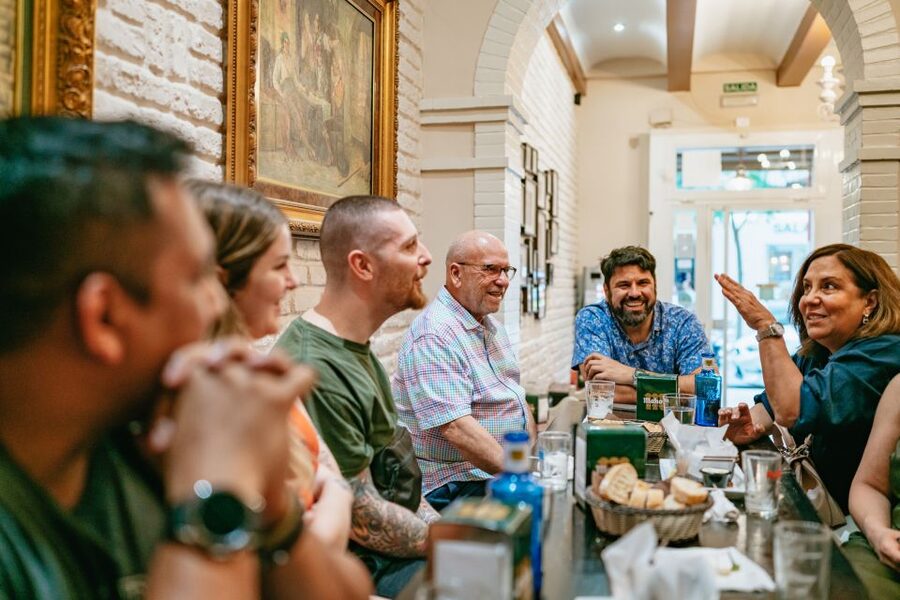 Madrid: Food & Wine Tour with 10 Tapas & 4 Drinks Included - Stop one: market cuisine and a first taste of Madrid