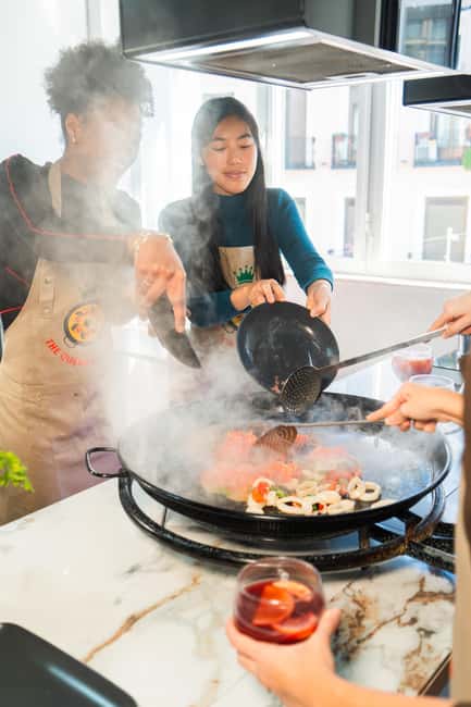 Madrid: Paella and Sangria Workshop with Tapas - Cooking paella in a Madrid bakery