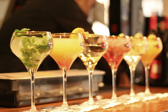 Nightlife Tour Drinks Tapas and Party Experience in Madrid - Walking Calle de la Montera after dark