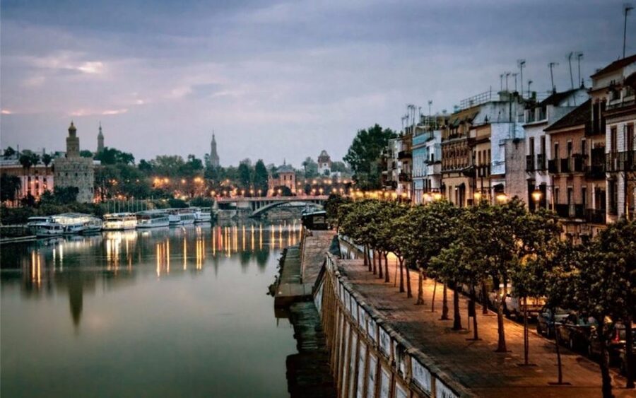Seville: Half-Day Flamenco & Tapas Night - Crossing the Isabel II Bridge and meeting Triana