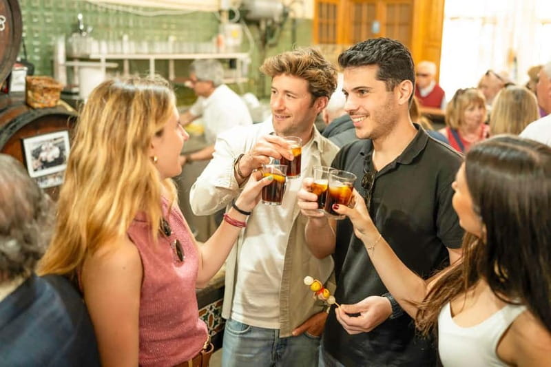 Seville: Private Tapas and Wine Tour with Rooftop Drink - Walking through Casco Antiguo and Santa Cruz