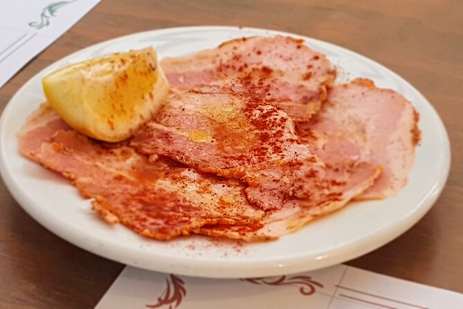 Taste of Malaga Tour : Tapas, History and Local Customs - Iberian ham and vermouth at a traditional grocery shop